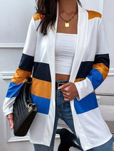 a woman in a white top and blue and yellow striped cardigan