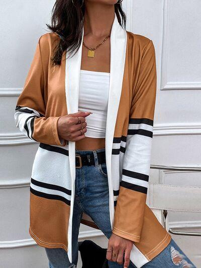 a woman wearing a brown and white striped cardigan