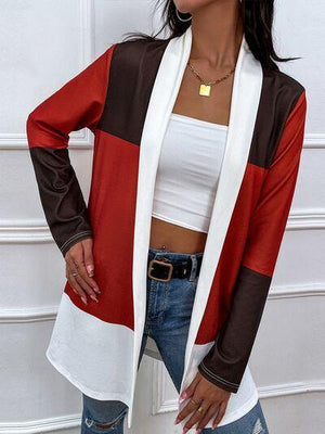 a woman wearing a white top and red cardigan