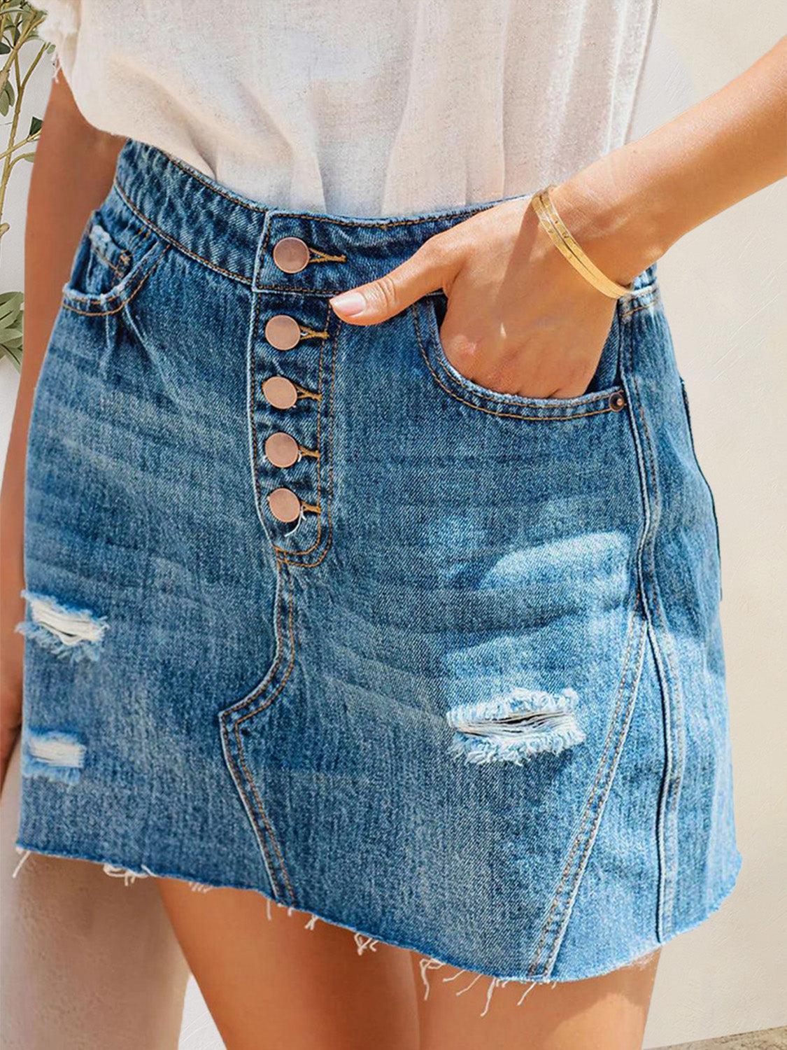 a woman wearing a denim skirt with holes