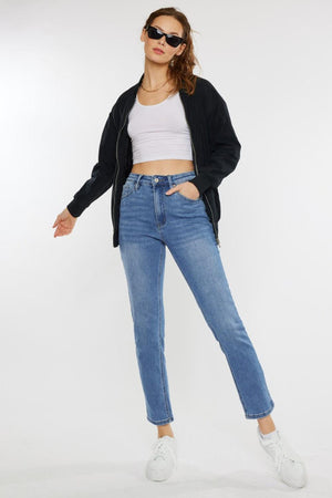 a woman in a white top and jeans