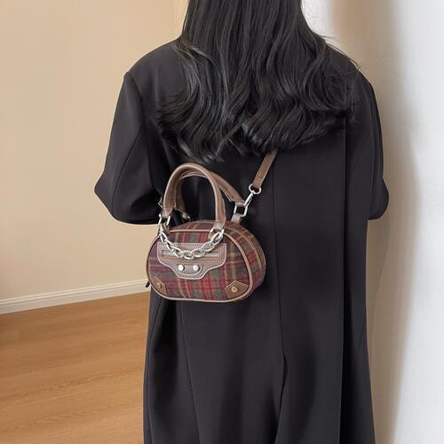 a woman with long black hair is holding a purse