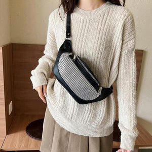 a woman wearing a white sweater and a black fanny bag