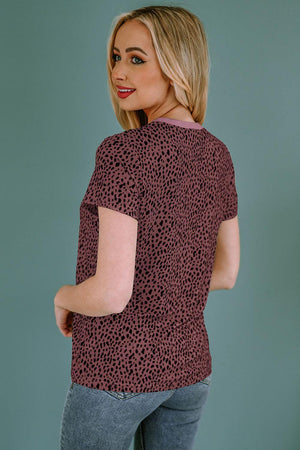 a woman wearing a red top with a leopard print