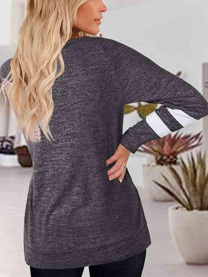 a woman standing in a room with her back to the camera