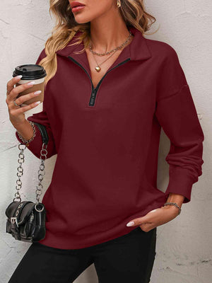 a woman wearing a red shirt and black pants
