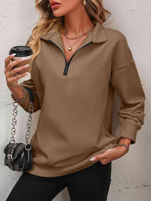 a woman wearing a brown shirt and black pants