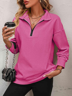 a woman wearing a pink shirt and black pants