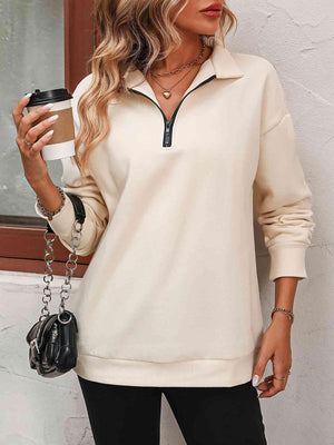 a woman holding a cup of coffee and a handbag