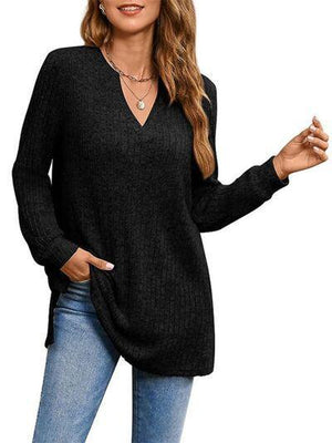 a woman wearing a black sweater and jeans