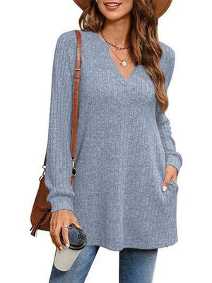 a woman wearing a blue sweater and hat