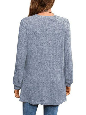 a woman wearing a blue sweater and jeans