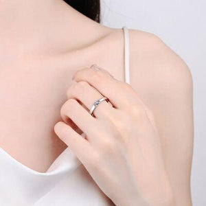 a woman wearing a ring with a diamond on it