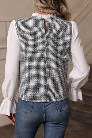 a woman wearing a white blouse and blue jeans