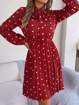 a woman wearing a red dress with white polka dots