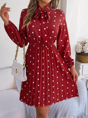 a woman wearing a red dress with white polka dots