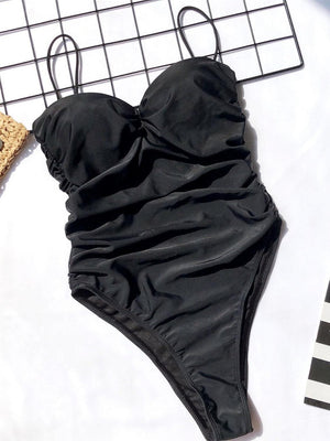 a black swimsuit laying on top of a table