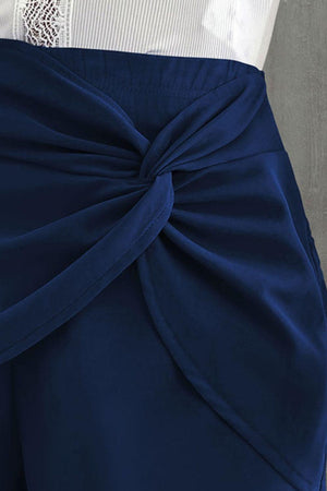 a close up of a person wearing a white shirt and blue pants