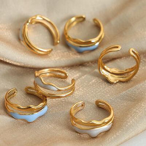 a group of gold and white rings sitting on top of a cloth