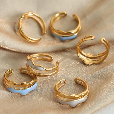 a group of gold and white rings sitting on top of a cloth