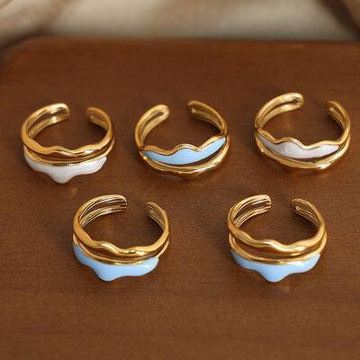 five pairs of gold and white rings on a table