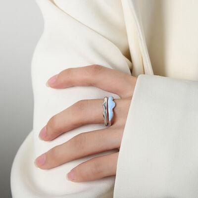 a woman wearing a white dress and a blue ring