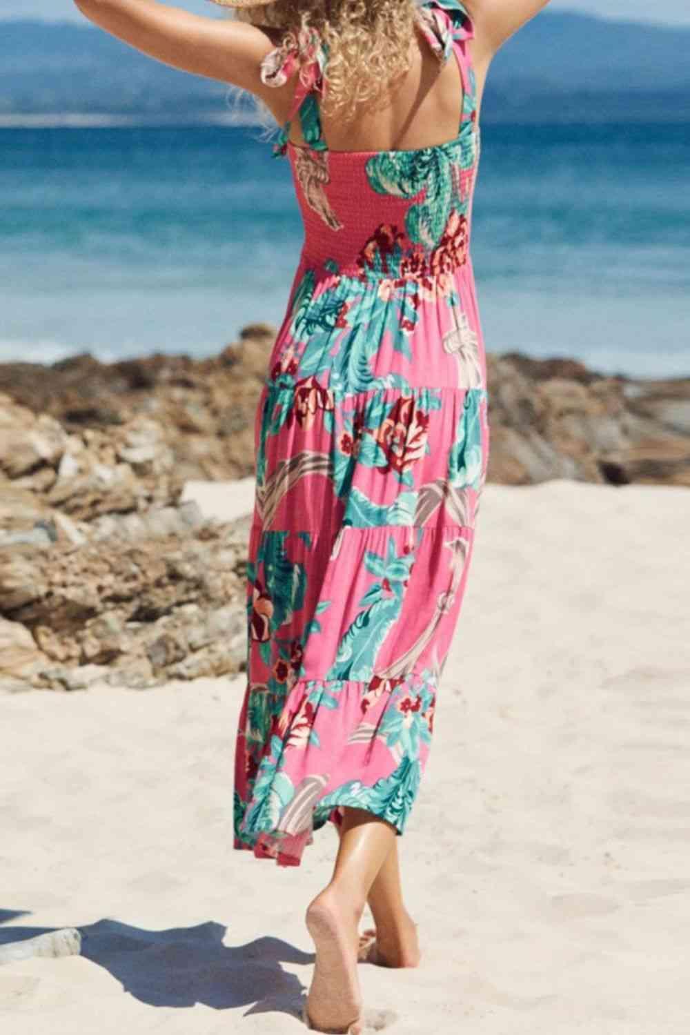a woman walking on a beach in a dress