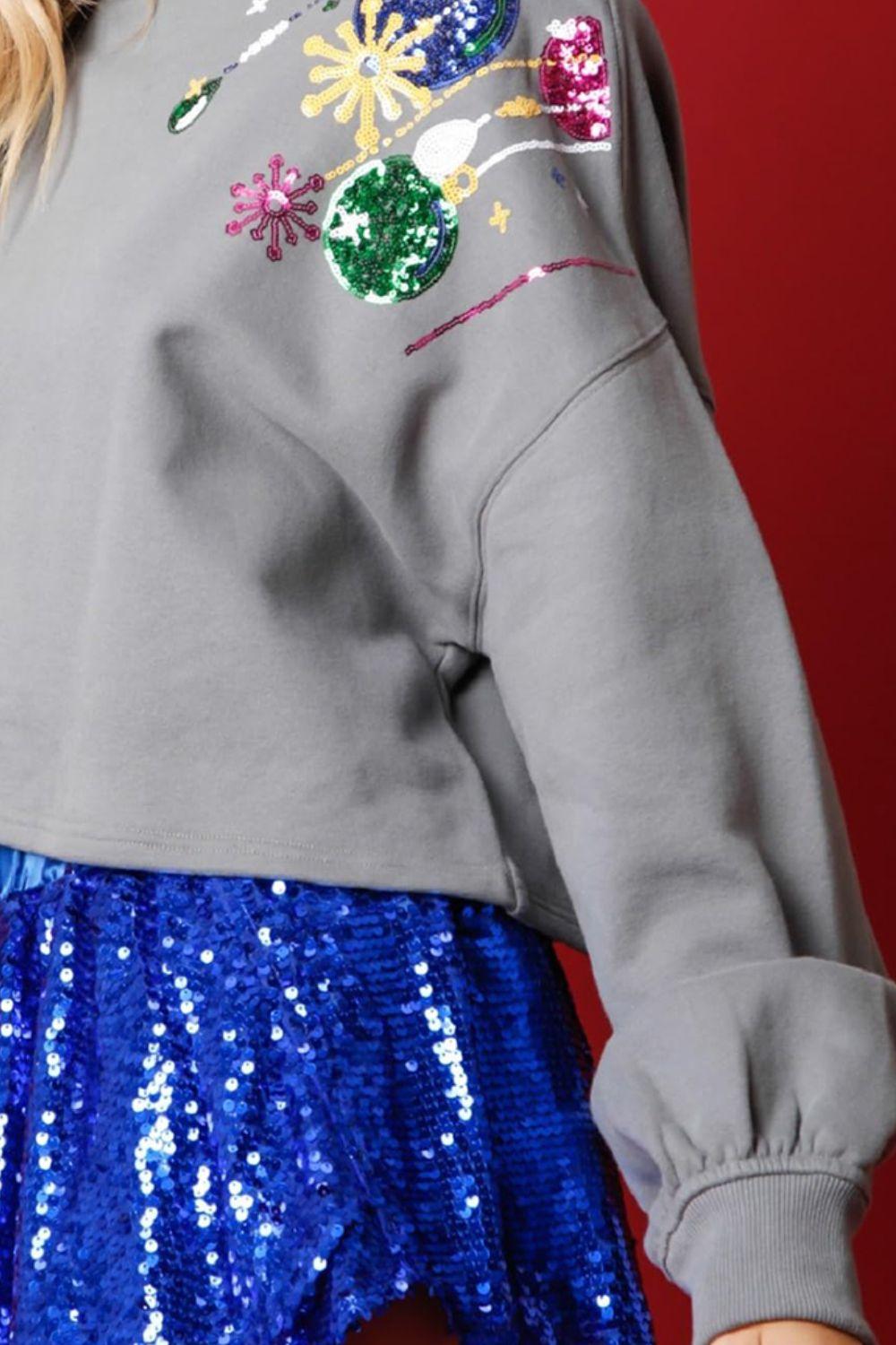 a close up of a person wearing a sequin skirt