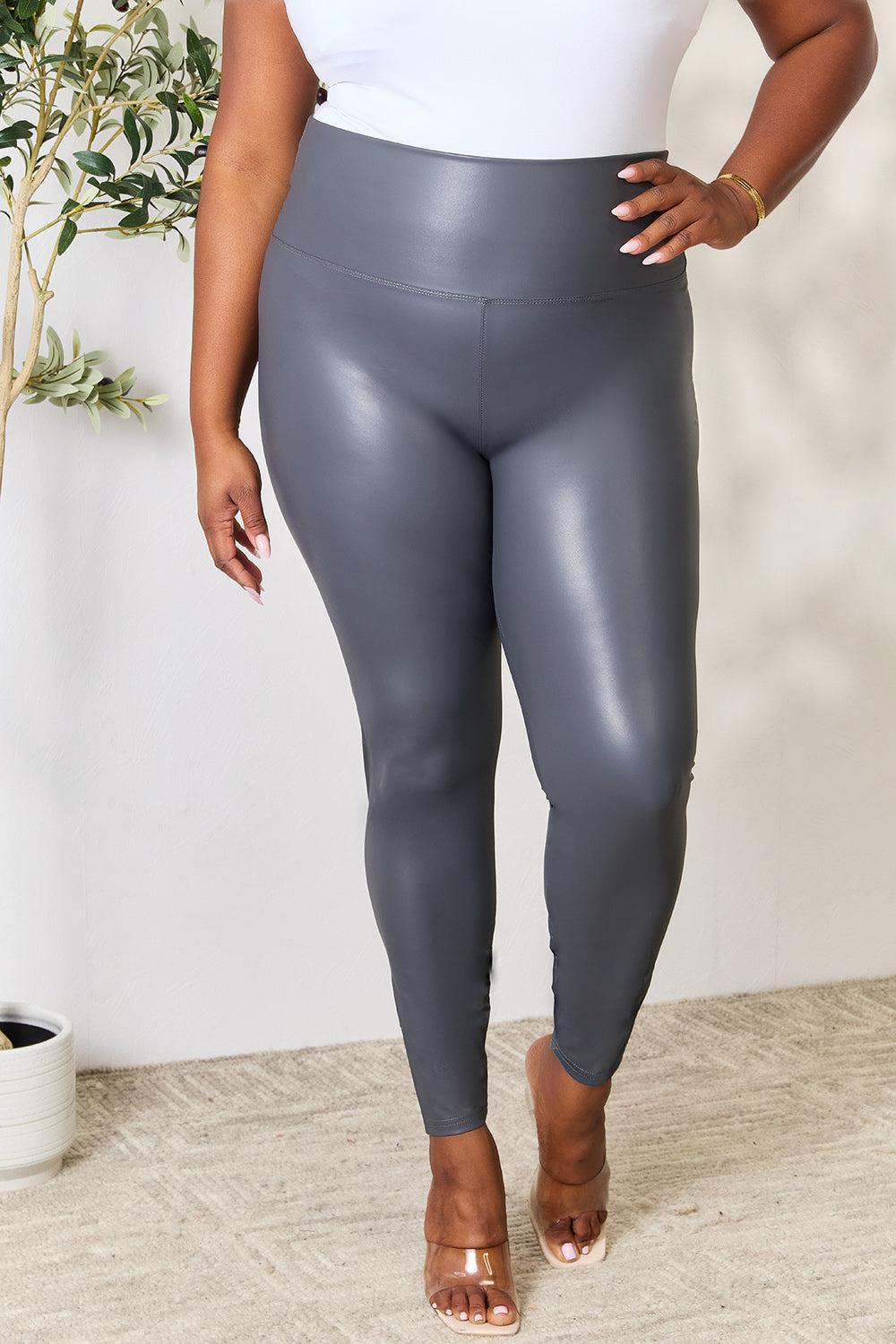 a woman in a white top and grey leggings