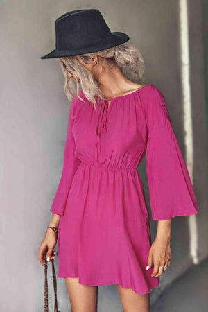 a woman wearing a pink dress and a black hat