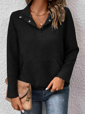 a woman wearing a black sweater and jeans
