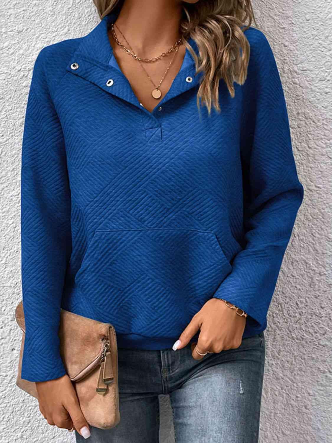 a woman wearing a blue shirt and jeans