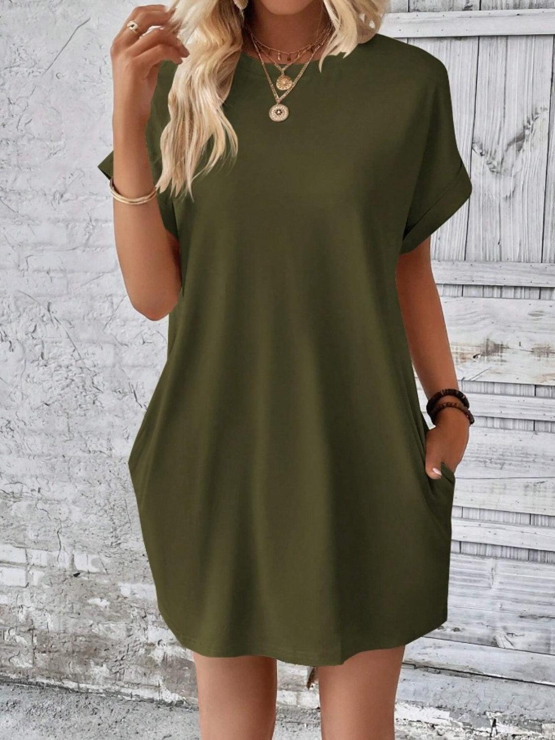 a woman wearing a green shirt dress