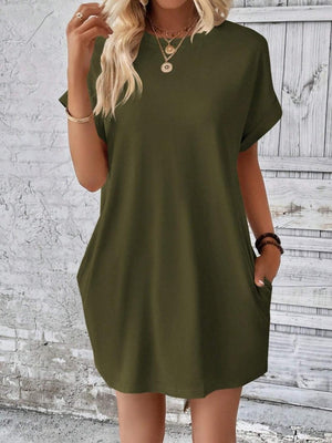a woman wearing a green shirt dress