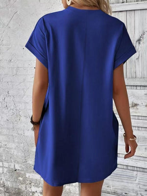 a woman wearing a blue shirt dress