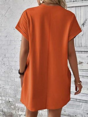 a woman wearing an orange shirt dress