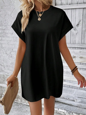 a woman wearing a black shirt dress