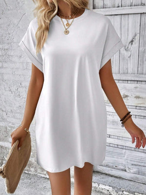 a woman wearing a white shirt dress