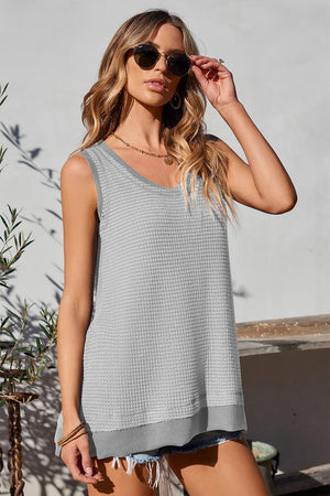 a woman wearing a tank top and shorts