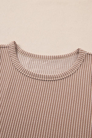 a brown and white striped shirt laying on top of a table