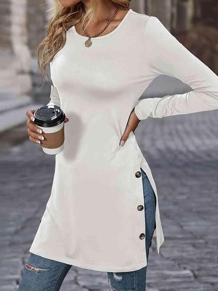 a woman wearing a white shirt and jeans holding a coffee