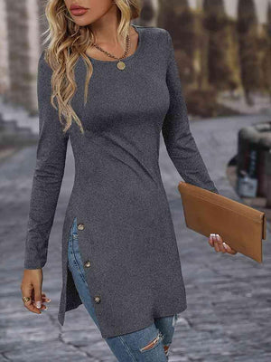 a woman walking down a street wearing a gray sweater