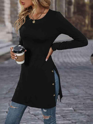 a woman in a black shirt and ripped jeans holding a coffee