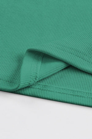 a close up of a green fabric on a white surface
