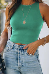 a woman wearing a green top and jeans