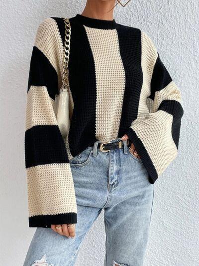 a woman wearing a black and white striped sweater