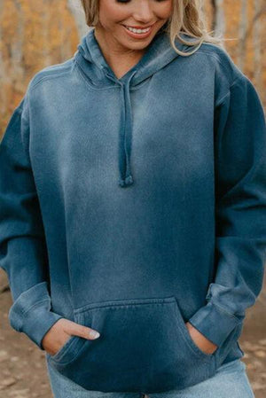 a woman wearing a blue sweatshirt and jeans