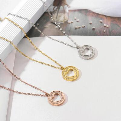 three different necklaces on a white surface