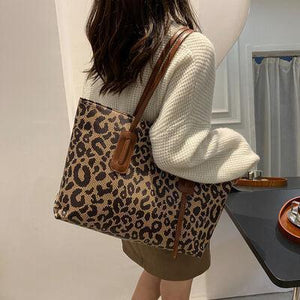 a woman carrying a leopard print purse