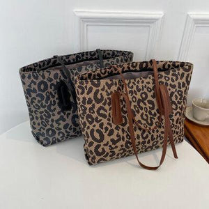 a pair of leopard print bags sitting on top of a table